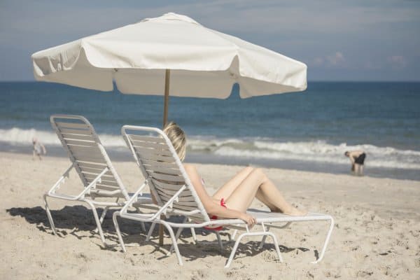Young woman sunbathing on rented beach chair at Vero Beach