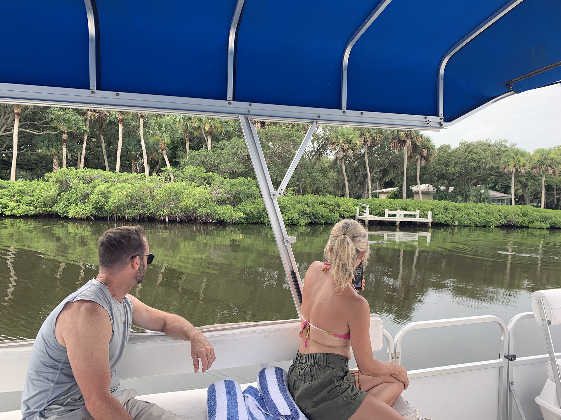 Couple enjoying a sight-seeing boat tour in the Indian River lagoon